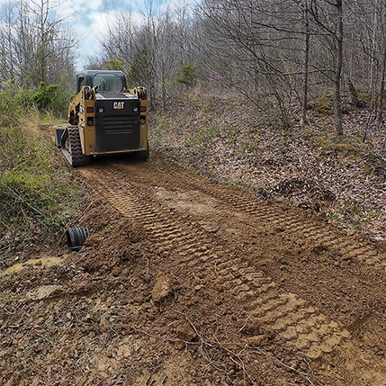 Installed culvert in a wooded trail.