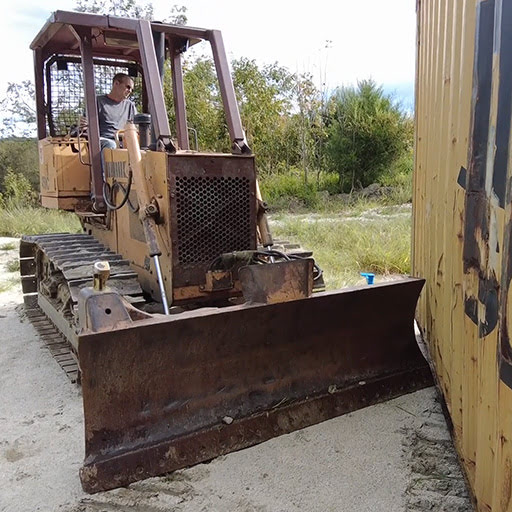 Moving a shipping container with a bull dozer